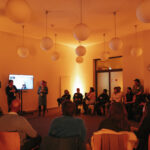 Workshop, People in a circle, 2 presenters and a sscreen
